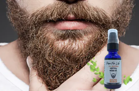 hairy man using beard oil with cannabidiol and full-spectrum marijuana terpenes