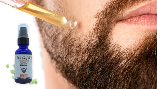 bearded man puts CBD beard oil on your hairy face