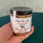 great penut butter made from cannabis in the hand of a happy person