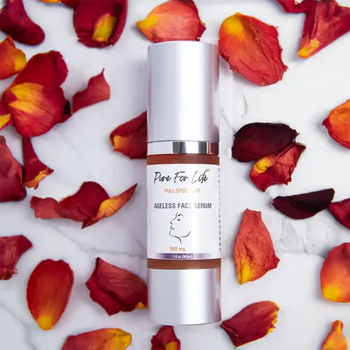 anti-aging face serum on a white table with flowers