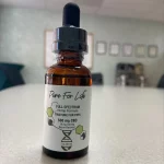 a bottle with CBD tincture for pets on a table in a laboratory