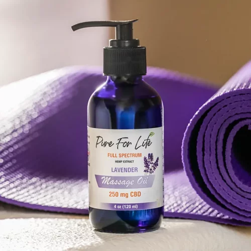 CBD oil for massaging in front of a training mat in violet color
