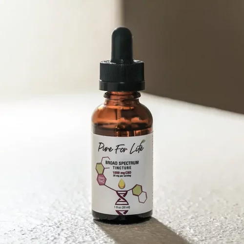 a bottle of broad spectrum cbd tincture on a table